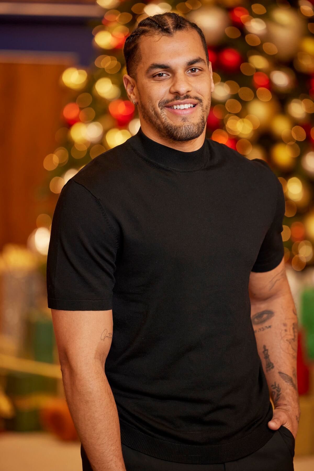 Josh Martinez of 'Big Brother Reindeer Games' posing in front of Christmas decorations