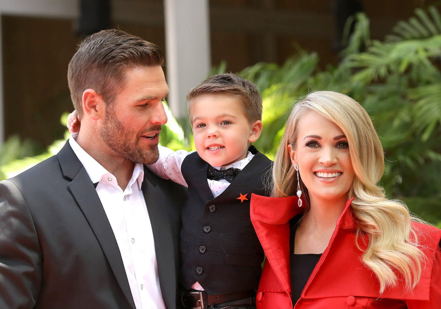 Carrie Underwood smiling with her husband and son