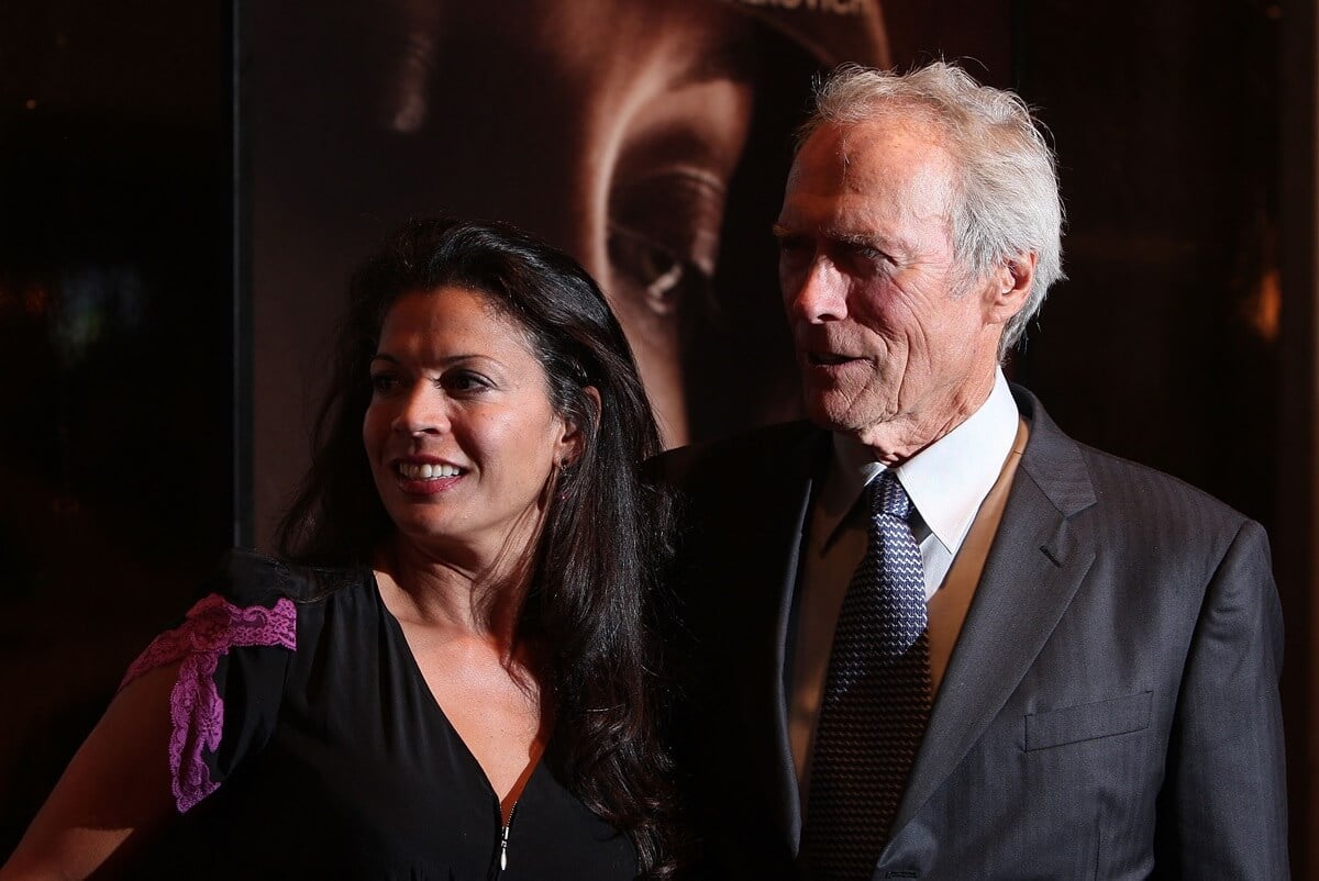 Clint Eastwood posing next to Dina Eastwood at the premiere of "The Changeling".