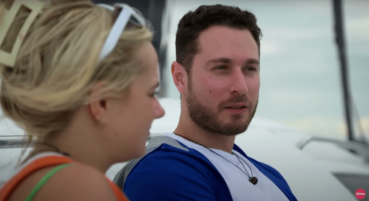 Emily, in profile, sitting next to Brennan on a boat in 'Married at First Sight' Season 17