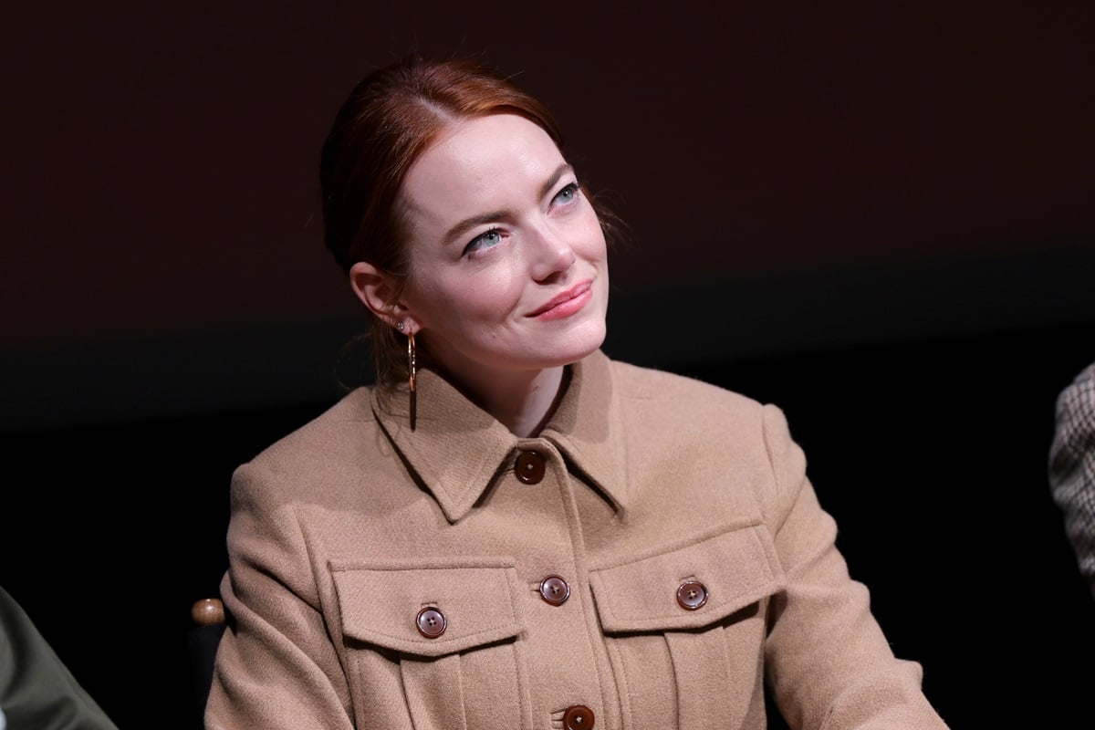 Emma Stone at a BAFTA screening for the movie 'Poor Things' in a brown jacket.