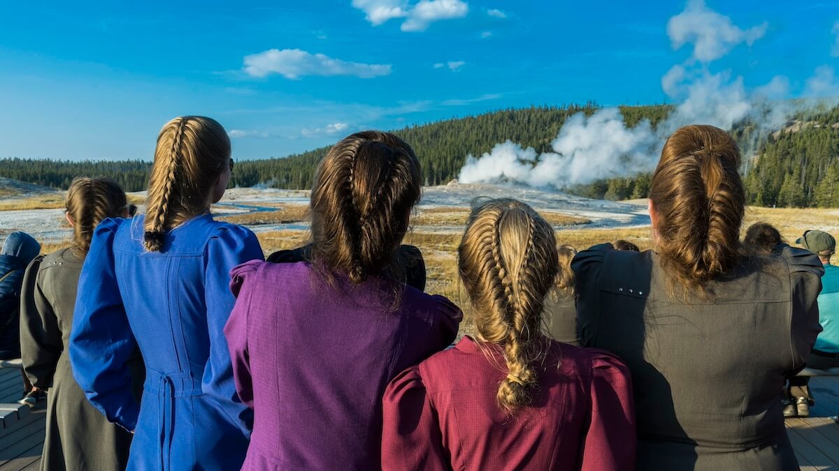 FLDS women looking at Old Faithful with their backs to the camera