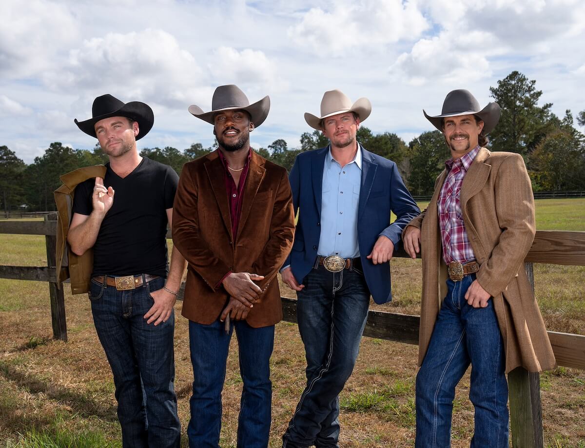 Hunter, Ryan, Landon, and Allen from 'Farmer Wants a Wife' Season 1 leaning against a split rail fence