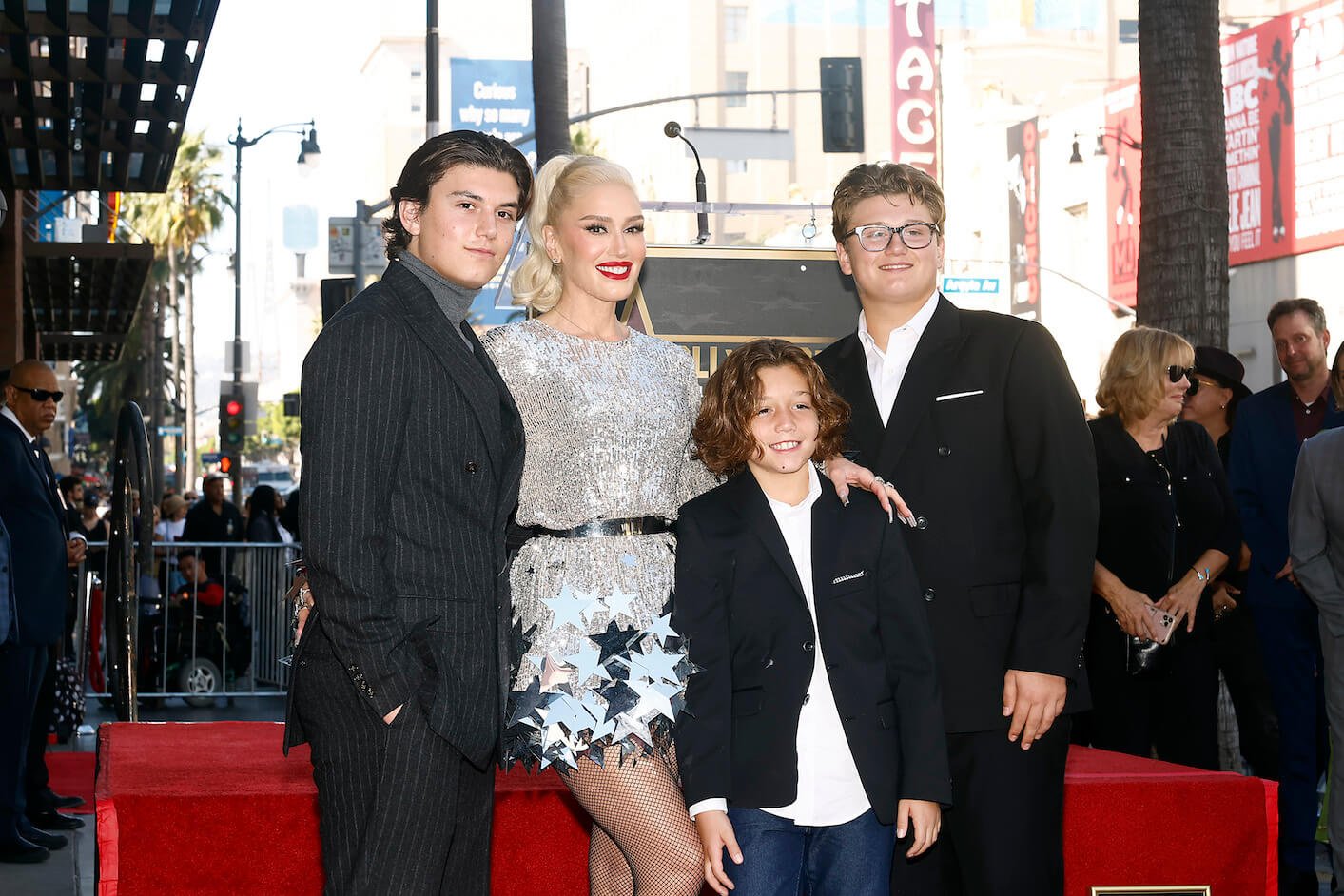 Gwen Stefani, Kingston Rossdale, Apollo Rossdale, and Zuma Rossdale stand together and smile at the Hollywood Walk of Fame Star Ceremony