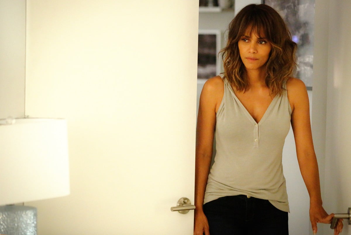 Halle Berry standing by a door in-character in the television show 'Extant'.