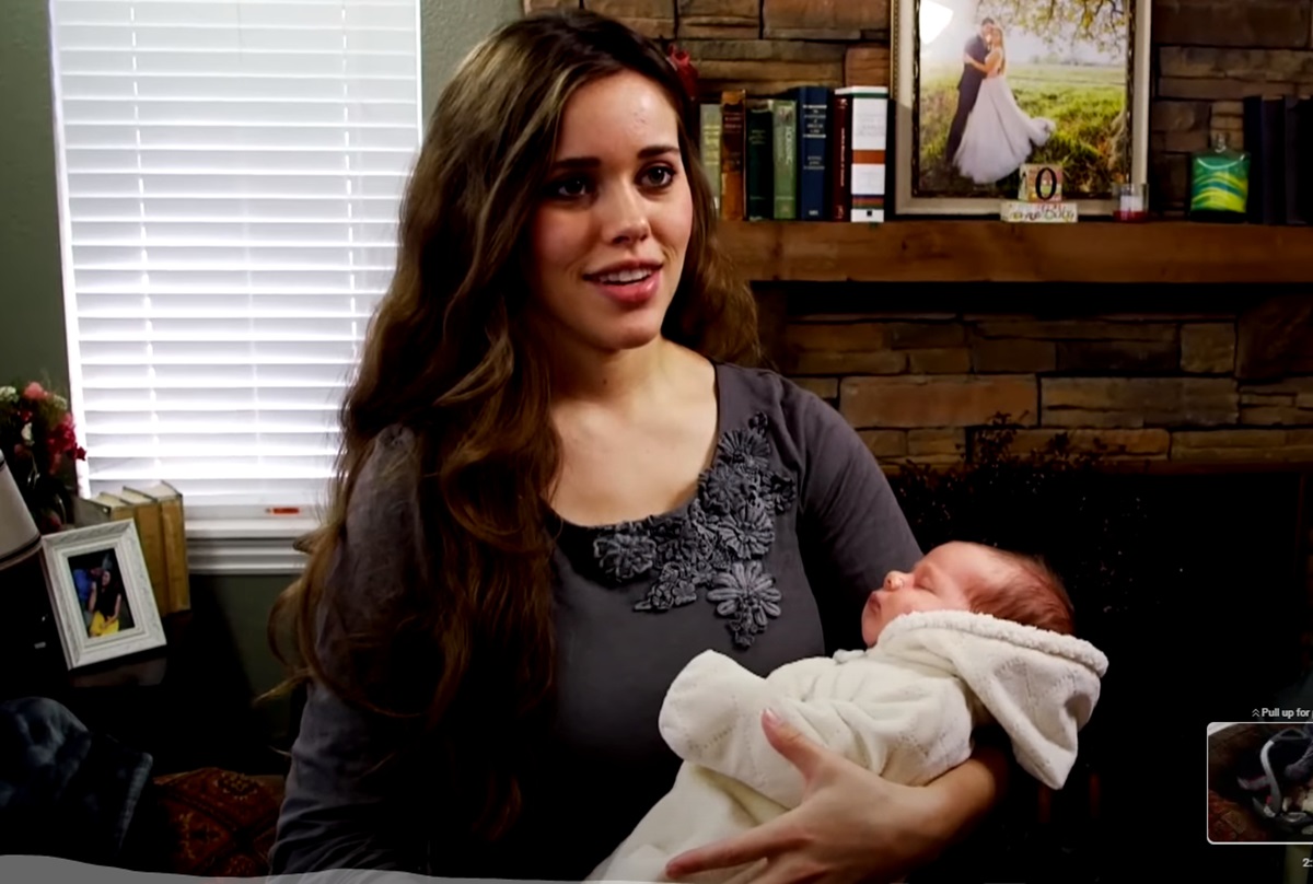 Jessa Seewald hold first child, Spurgeon Elliot, as a newborn.