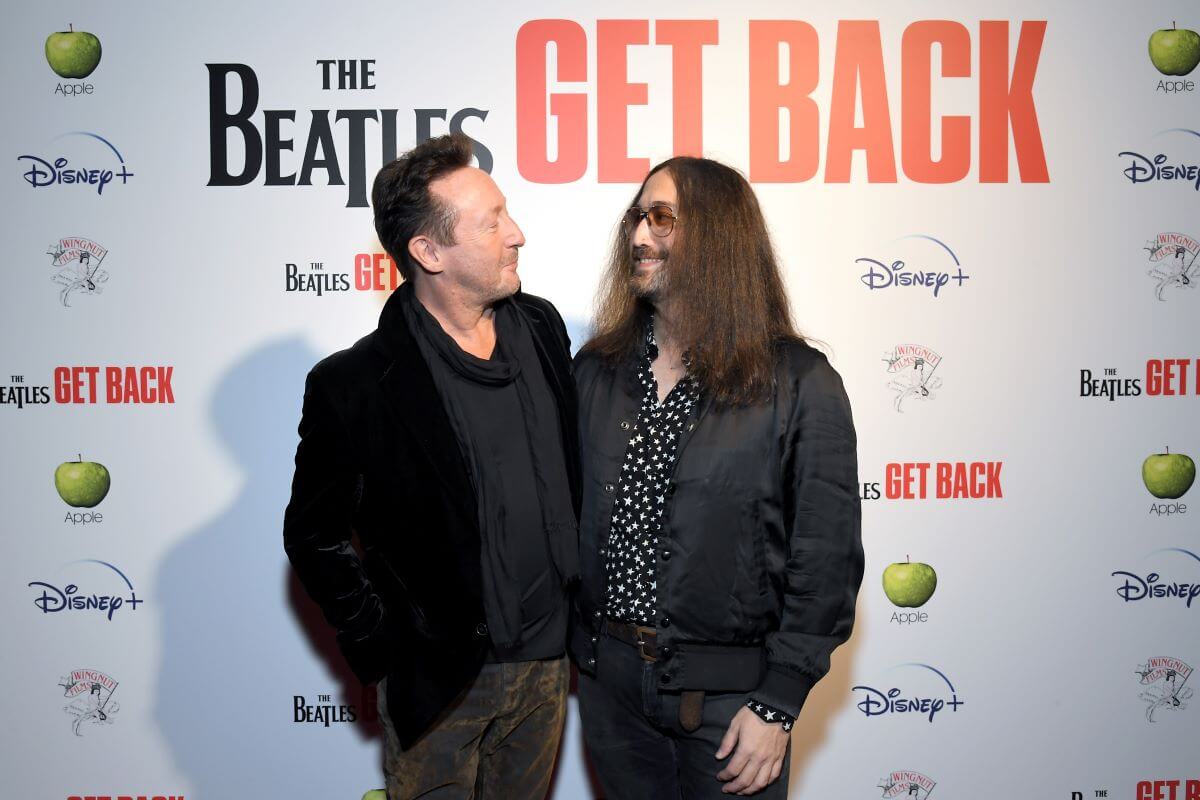 Julian and Sean Lennon look at each other on a step and repeat for 'The Beatles: Get Back.'