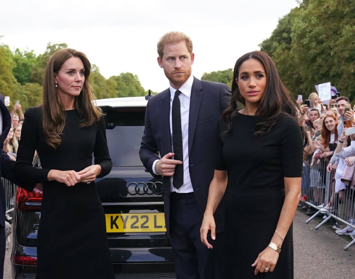 Kate Middleton, Prince Harry, and Meghan Markle meet members of the public on the Long Walk at Windsor Castle