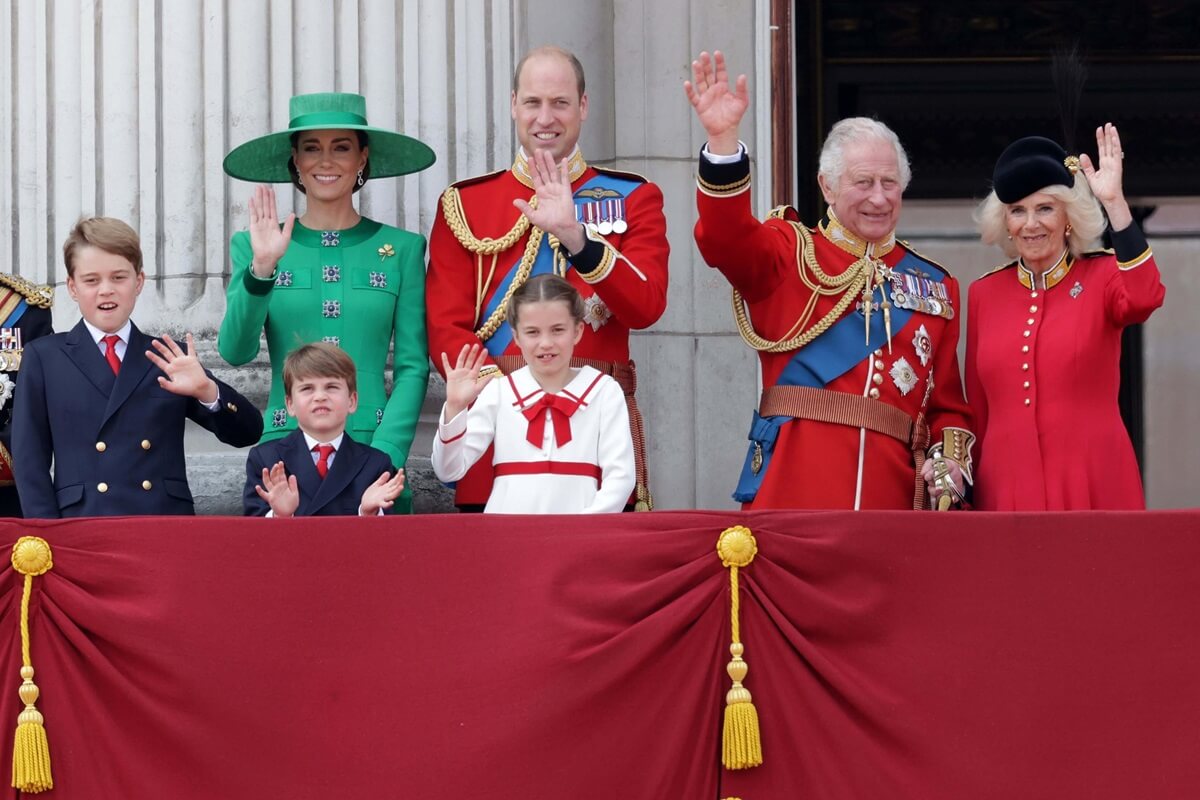 King Charles III and other members of the royal family stand on the balcony of Buckingham Palace to watch a flypast of aircraft during Trooping the Colour