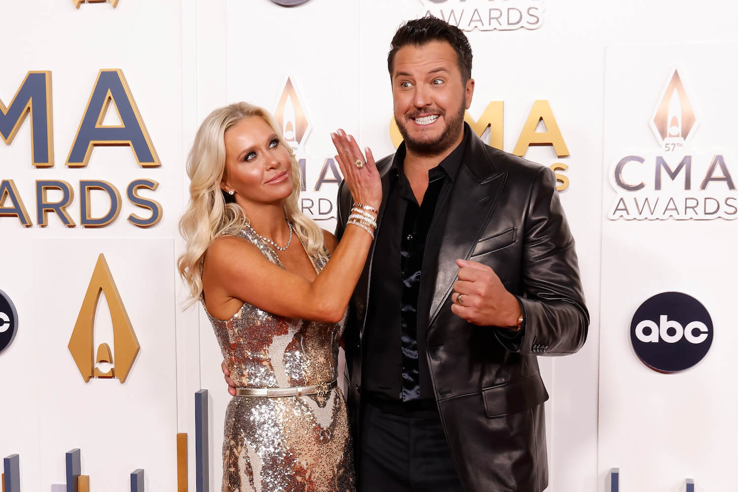 Luke Bryan striking a funny pose with his wife, Caroline Bryan, at the 2023 CMA Awards