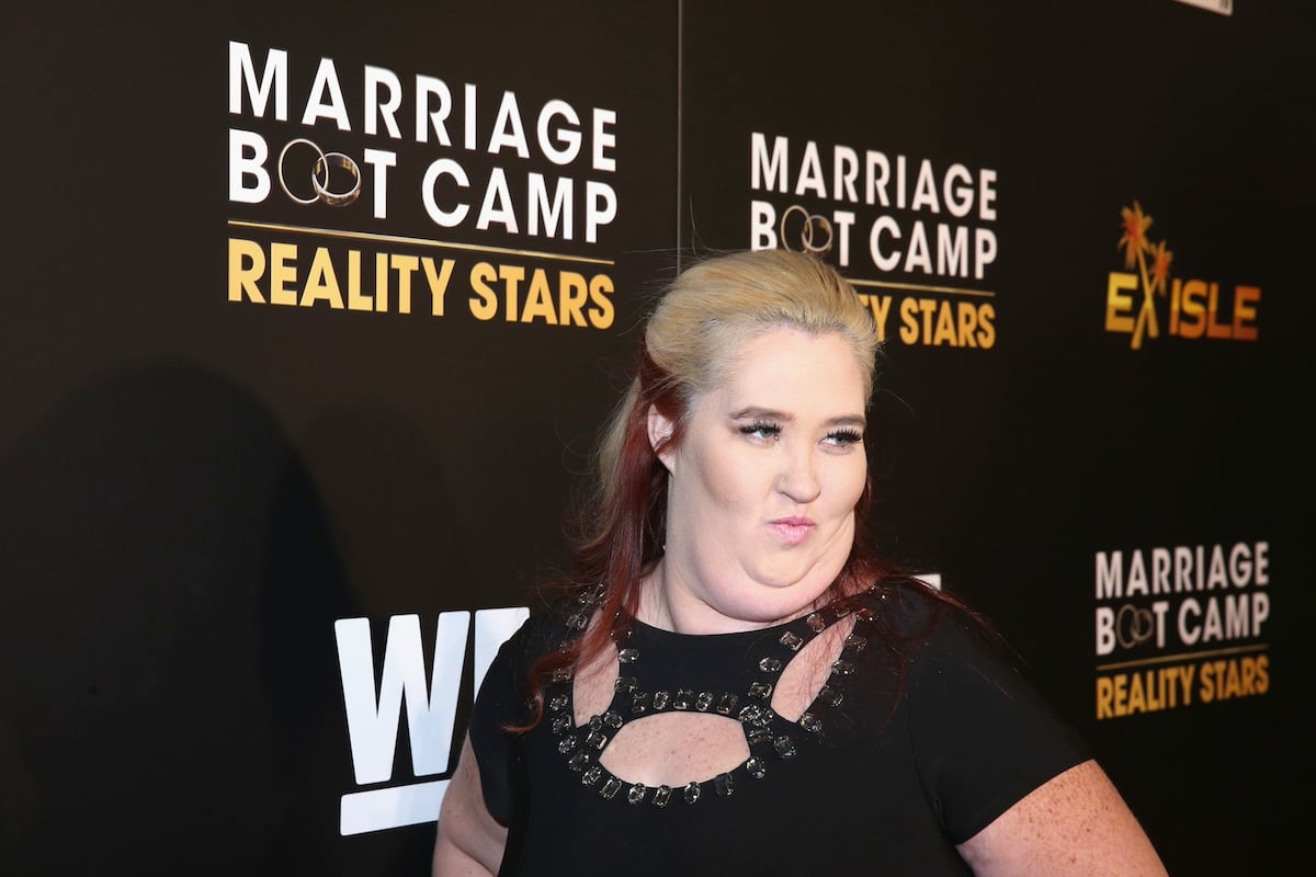 Mama June Shannon of 'Here Comes Honey Boo Boo' in a black dress posing on the red carpet
