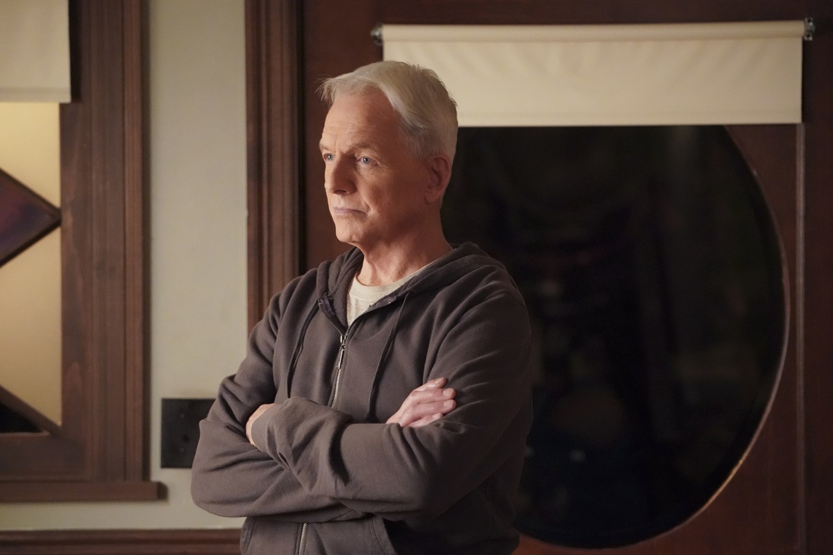 Mark Harmon posing in a scene in 'NCIS' while wearing a sweater.
