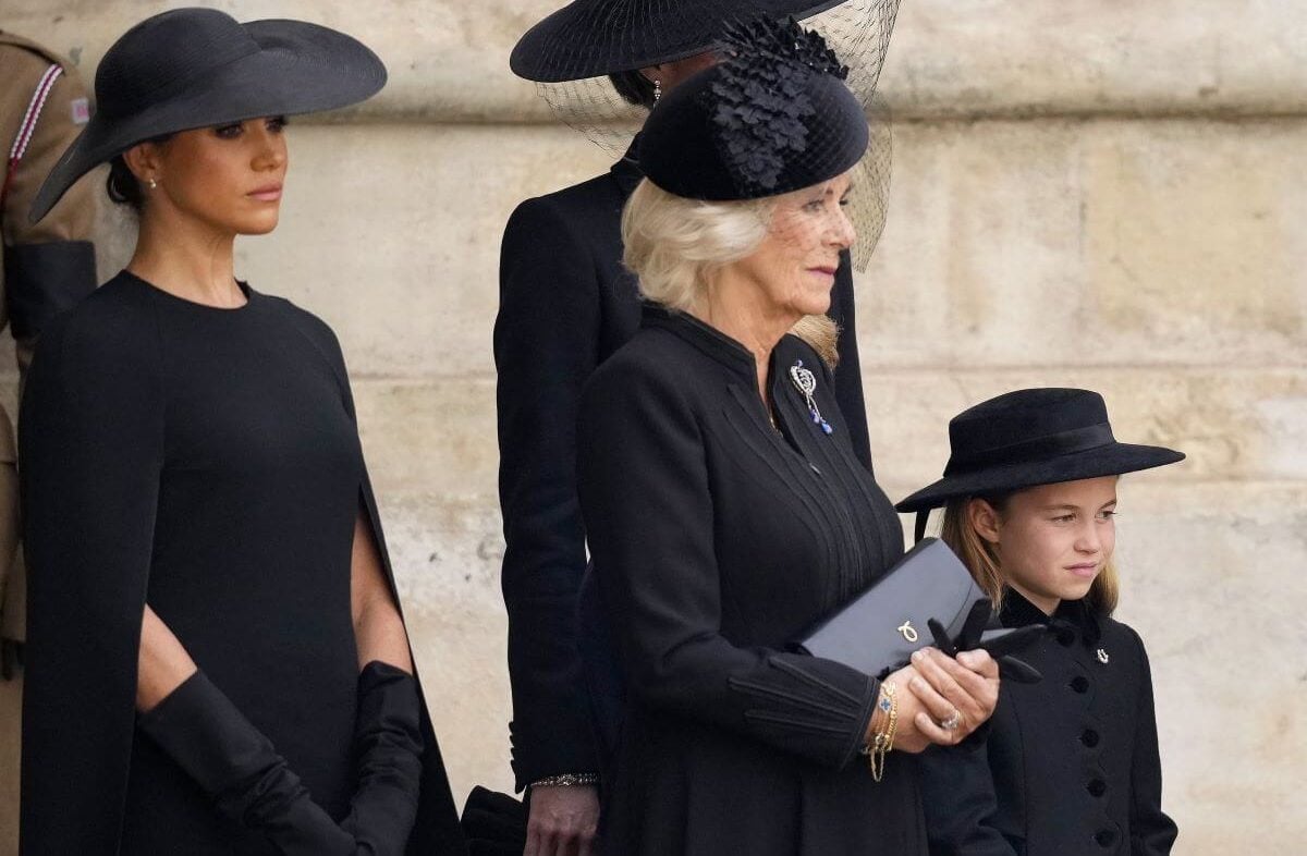 Meghan Markle, Princess Charlotte, and other members of the royal family watch as Queen Elizabeth II's funeral cortege departs Westminster Abbey