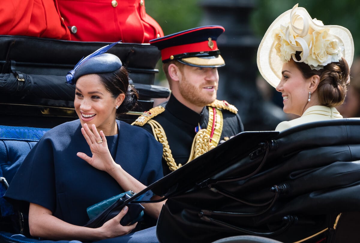 Meghan Markle and Prince Harry, who may be upset by Kate Middleton's 'Together at Christmas' 2023 carol service theme, sit with Kate Middleton