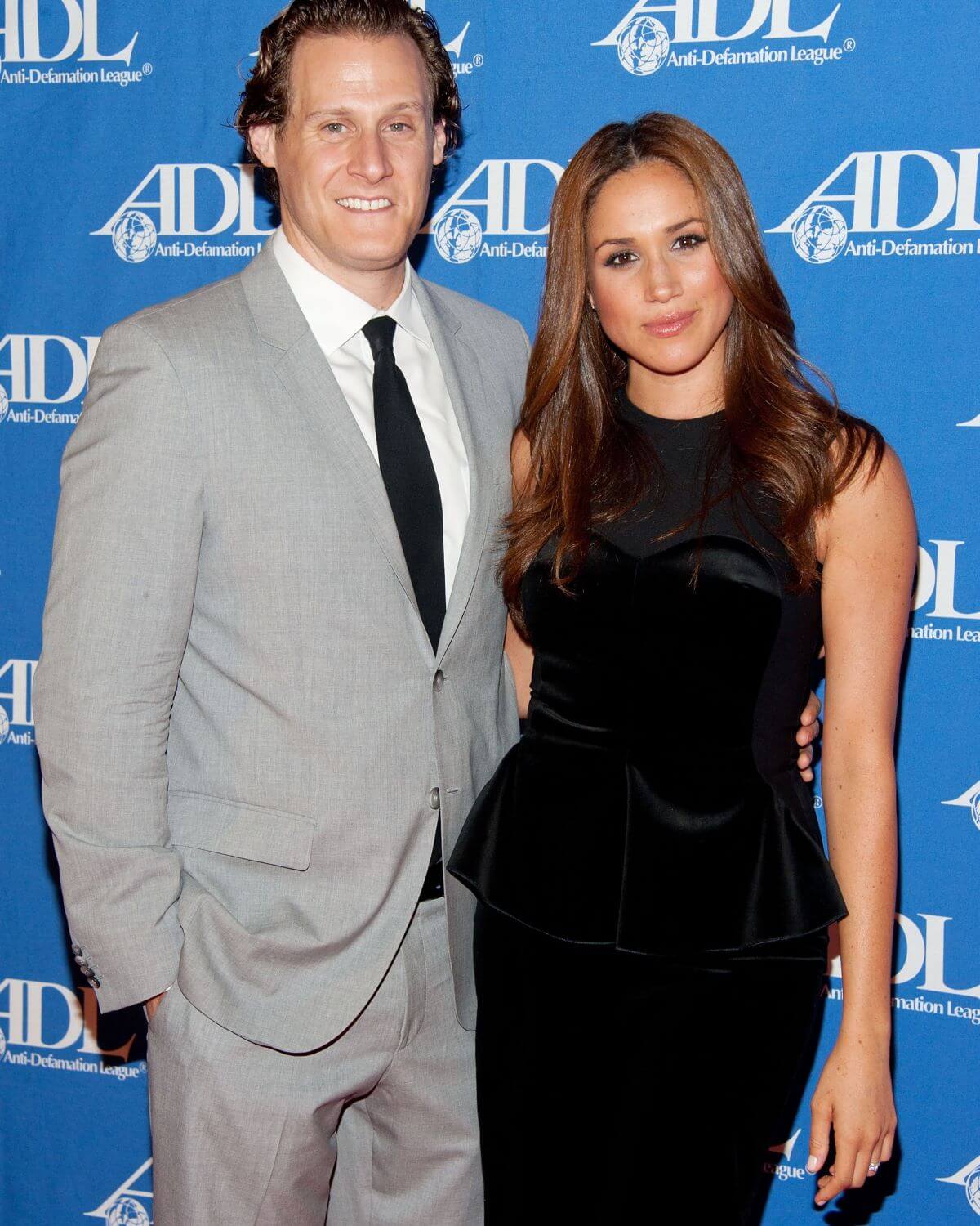 Meghan Markle and Trevor Engelson smile on the carpert at the Anti-Defamation League Entertainment Industry Awards Dinner