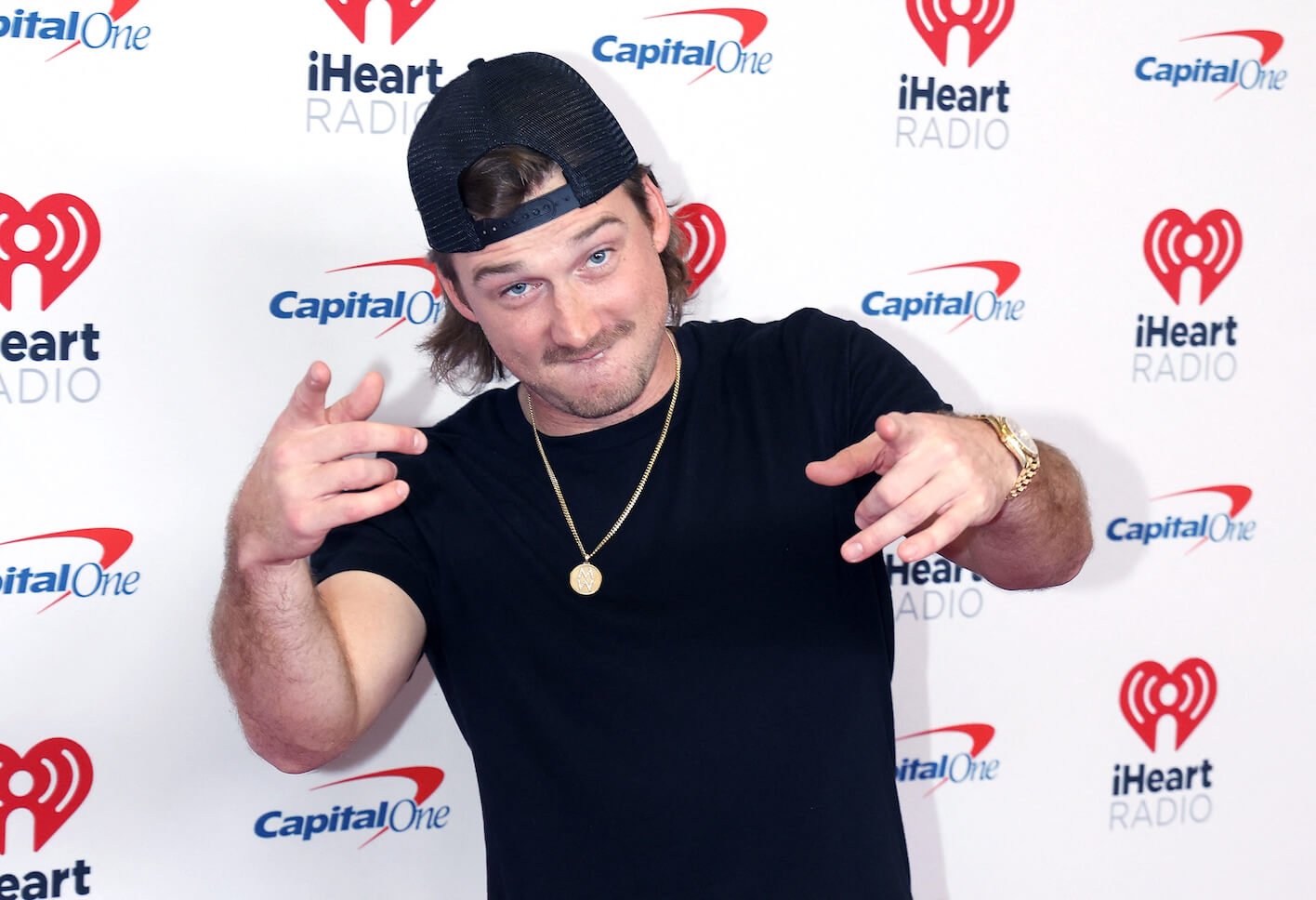 Morgan Wallen pointing to the camera and smiling