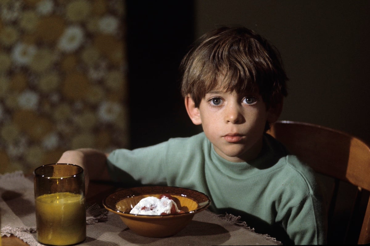 Jeremy Gelbwaks of 'The Partridge Family' sitting at a table in front of a bowl of cereal