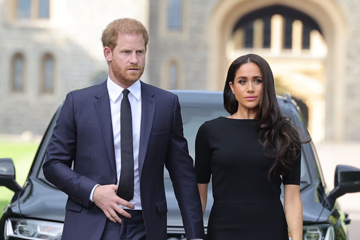 Prince Harry and Meghan Markle, who a commentator says are 'keeping their mouths shut' to 'trick people,' arrive at Windsor Castle to view flowers and tributes to Queen Elizabeth II