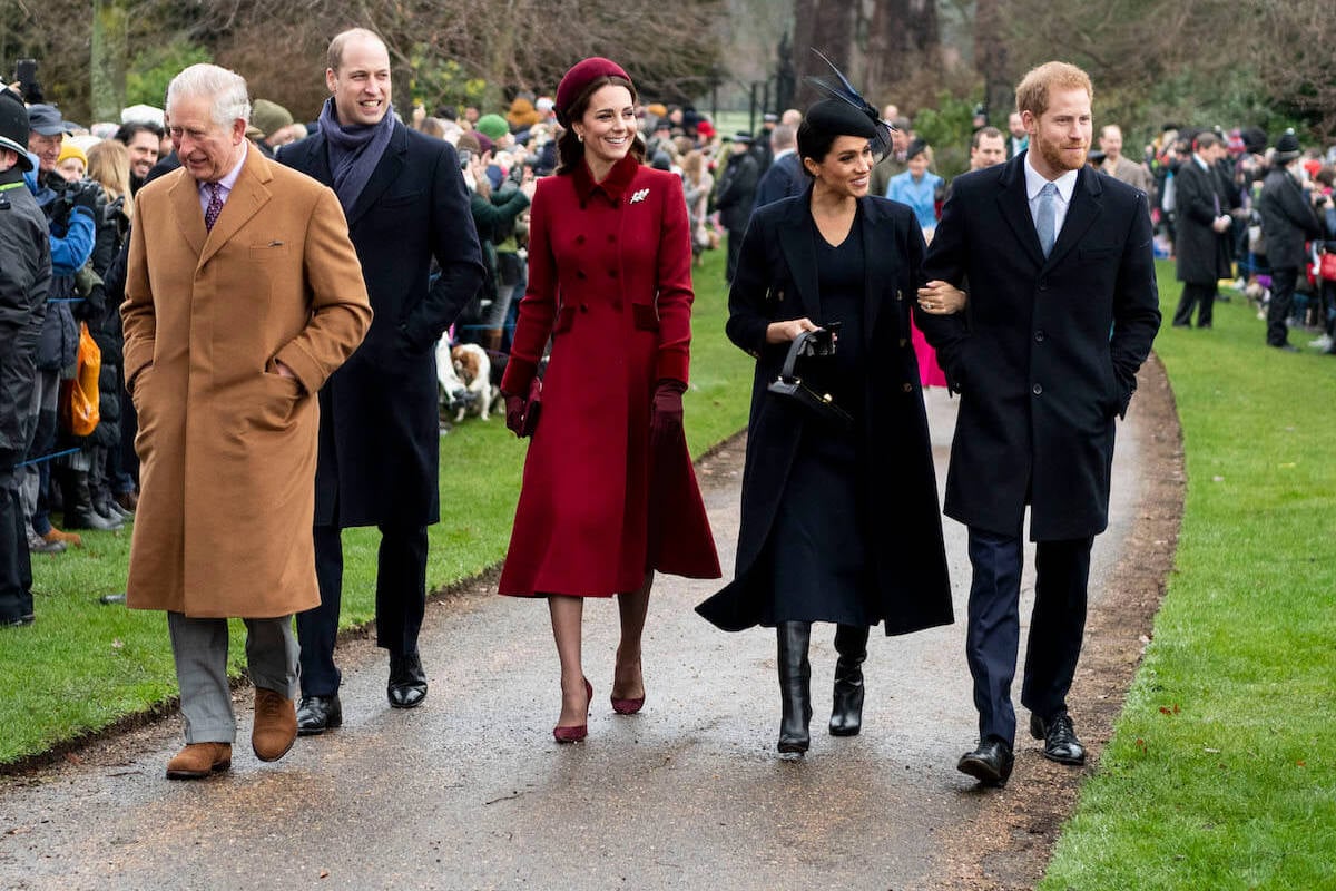 Prince Harry and Meghan Markle, who are one of many problems for the royal family, per a commentator, walk with King Charles, Prince William, and Kate Middleton