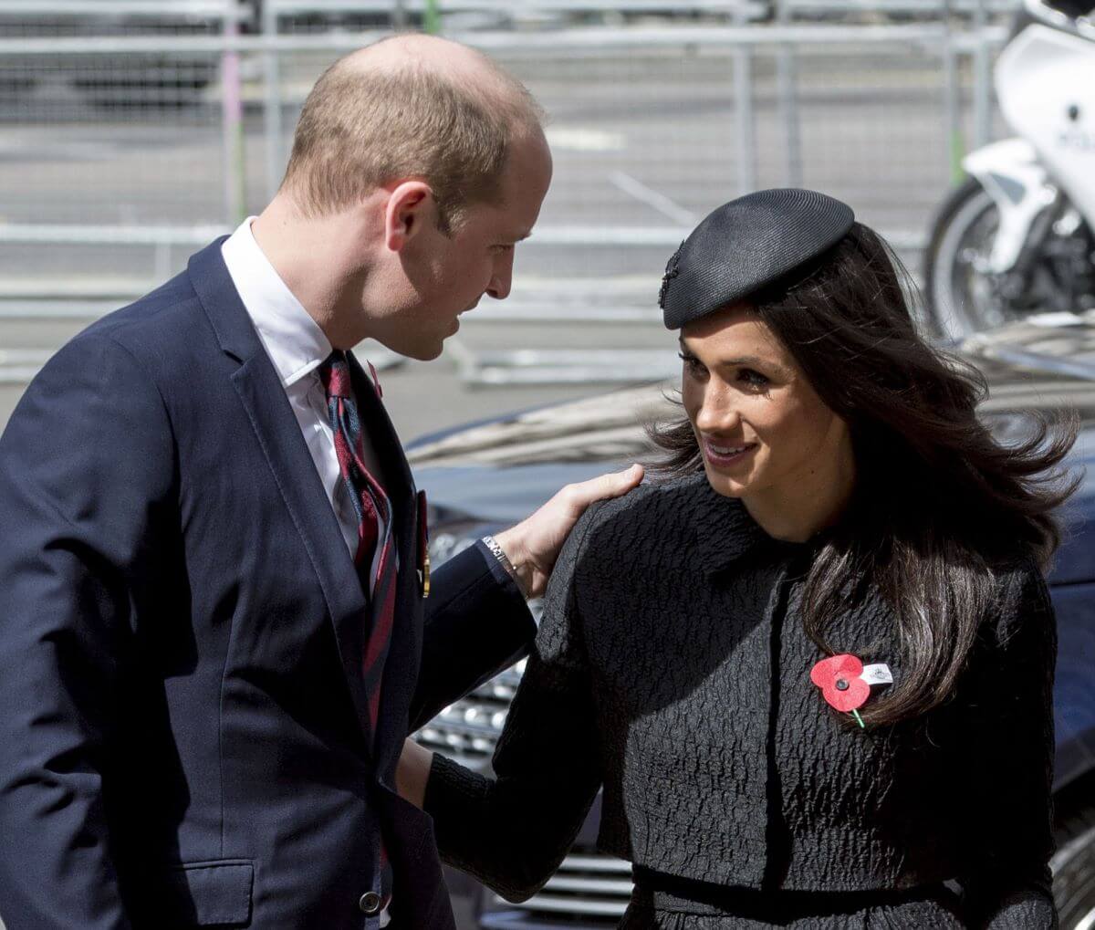Prince William greets Meghan Markle as they attend an Anzac Day service at Westminster Abbey