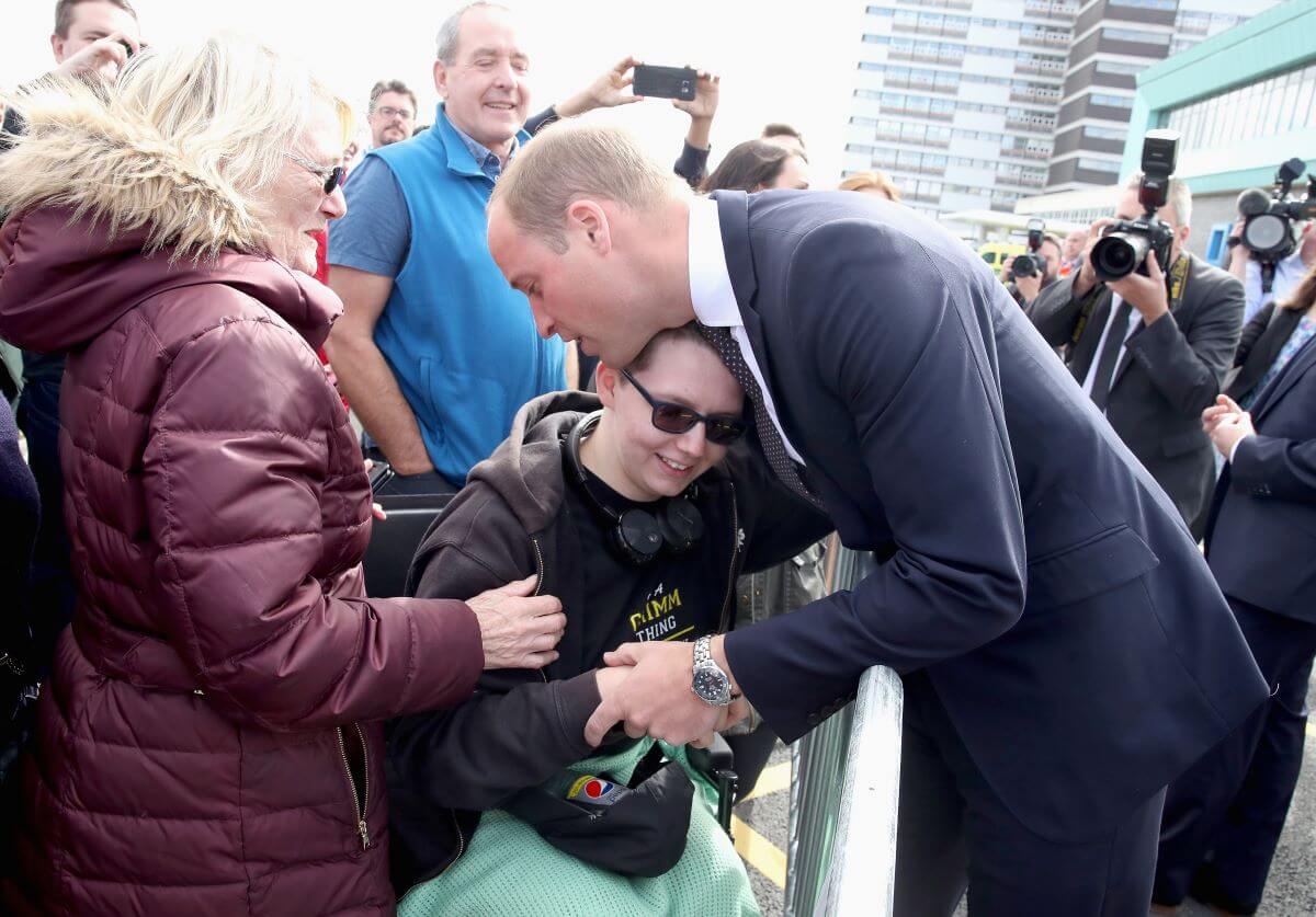 Prince William hugs a woman named Katie Daley during a visit to Aintree University Hospital in Liverpool, England