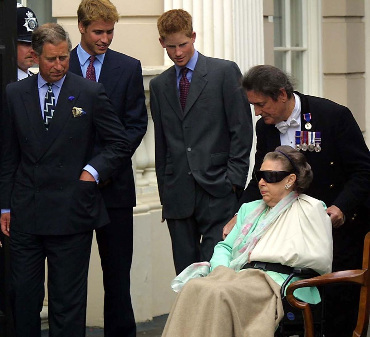 Princess Margaret being wheeled out by stewart William Tallon as the-Prince Charles, Prince William, and Prince Harry look on