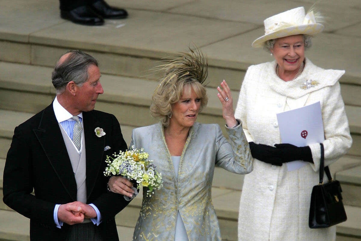 Queen Elizabeth II, who gave a speech at King Charles and Queen Camilla's 2005 wedding reception, stands behind the bride and groom