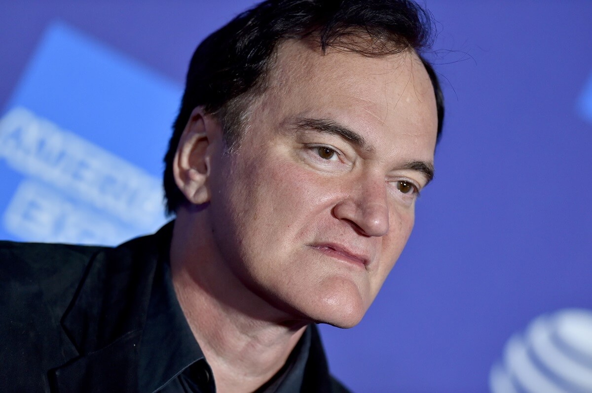 Quentin Tarantino posing in a black suit at the 2020 Annual Palm Springs International Film Festival Film Awards Gala.