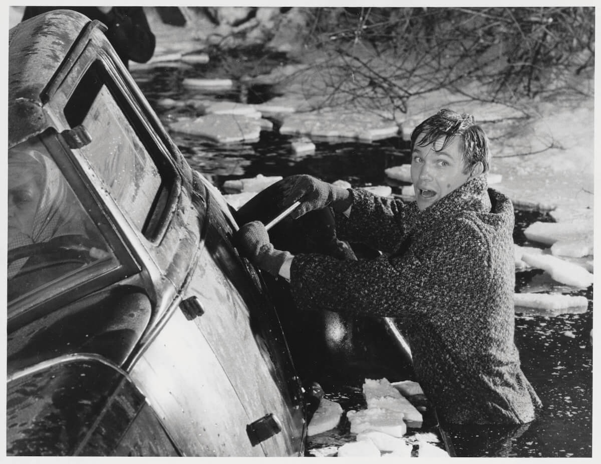 Richard Thomas in an icy river next to a sinking car in 'The Waltons'