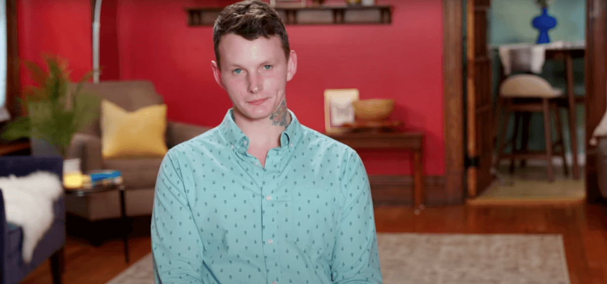 Sam from '90 Day Fiancé' Season 10 gives an interview in a blue button down shirt