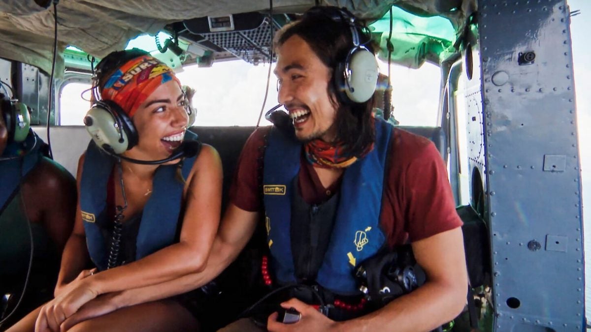 Dee Valladares and Austin Li Coon holding hands in a helicopter in 'Survivor' 45