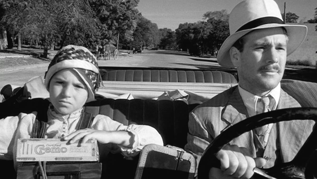 Black and white photo of Tatum O'Neal and Ryan O'Neal in a car in 'Paper Moon'