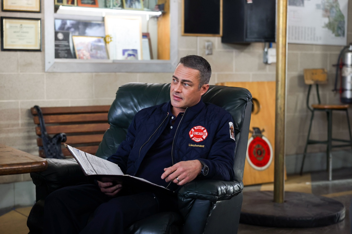 Taylor Kinney as Kelly Severide sitting with folder in a lap in 'Chicago Fire' Season 11