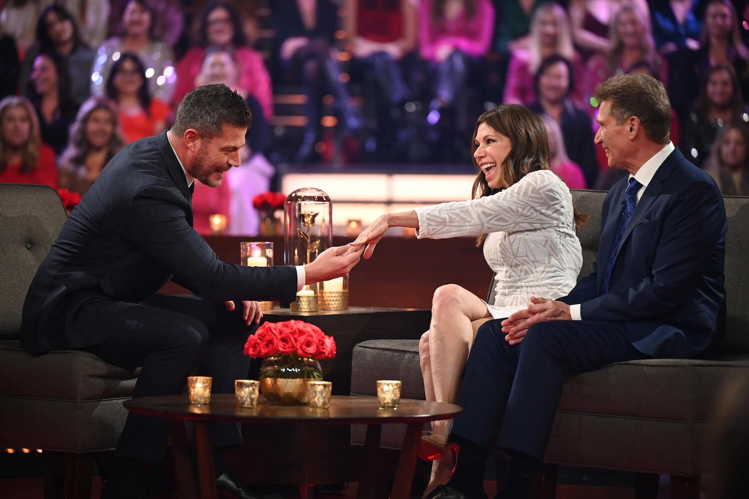 'The Golden Bachelor' winner Theresa Nist showing her engagement ring to Jesse Palmer while sitting next to Gerry Turner during the After the Final Rose