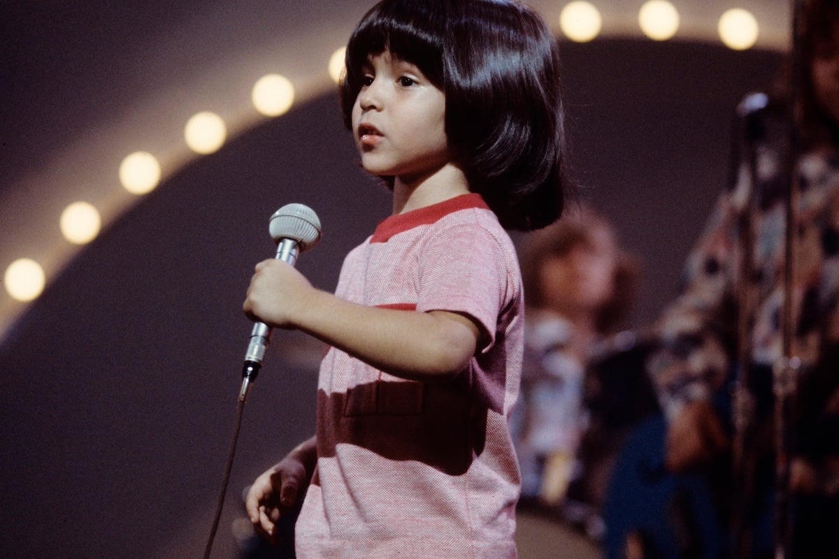Ricky Segall holding a microphone in an episode of 'The Partridge Family'