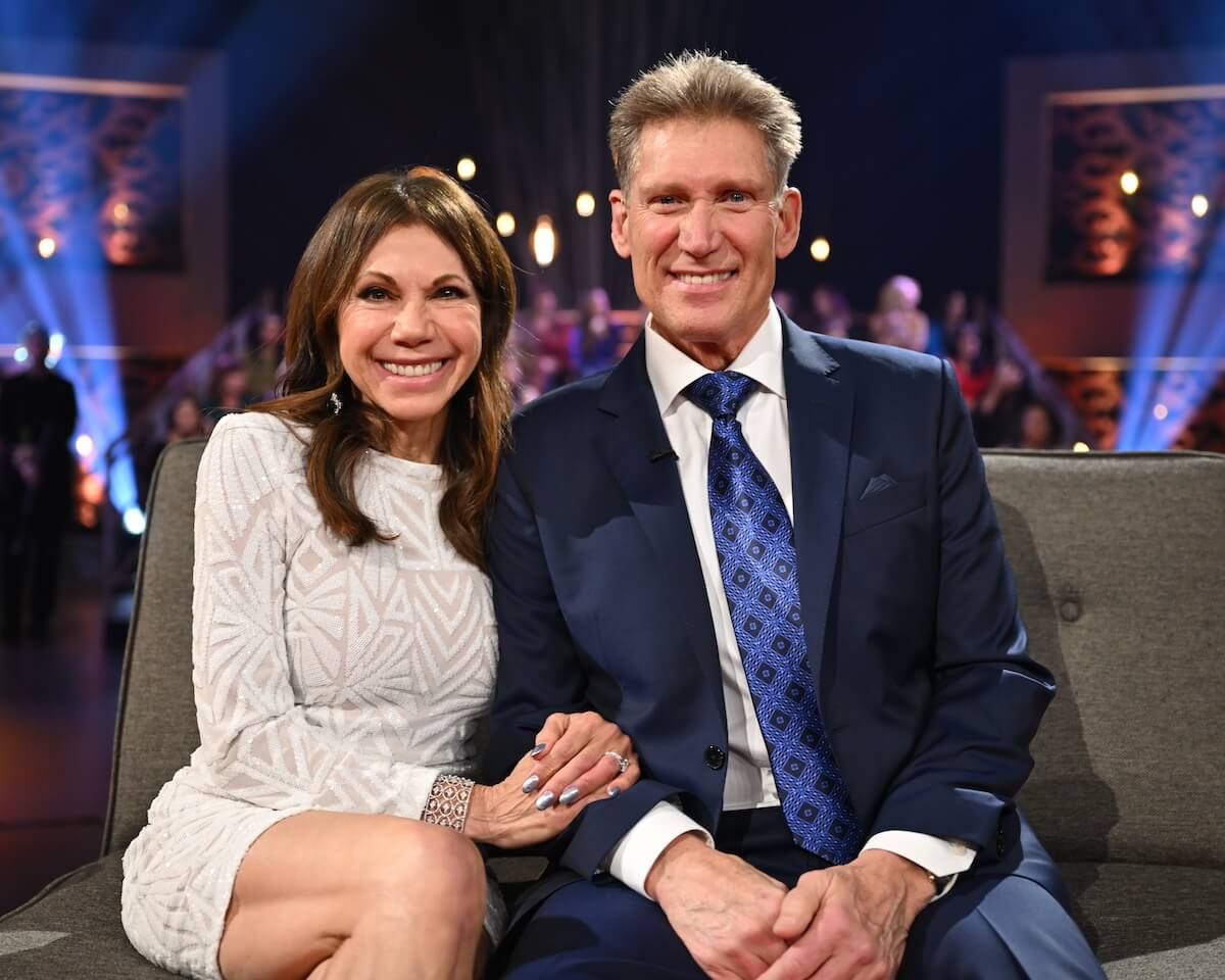 'The Golden Bachelor' star Theresa Nist in a white dress sitting close to Gerry Turner in a blue suit.