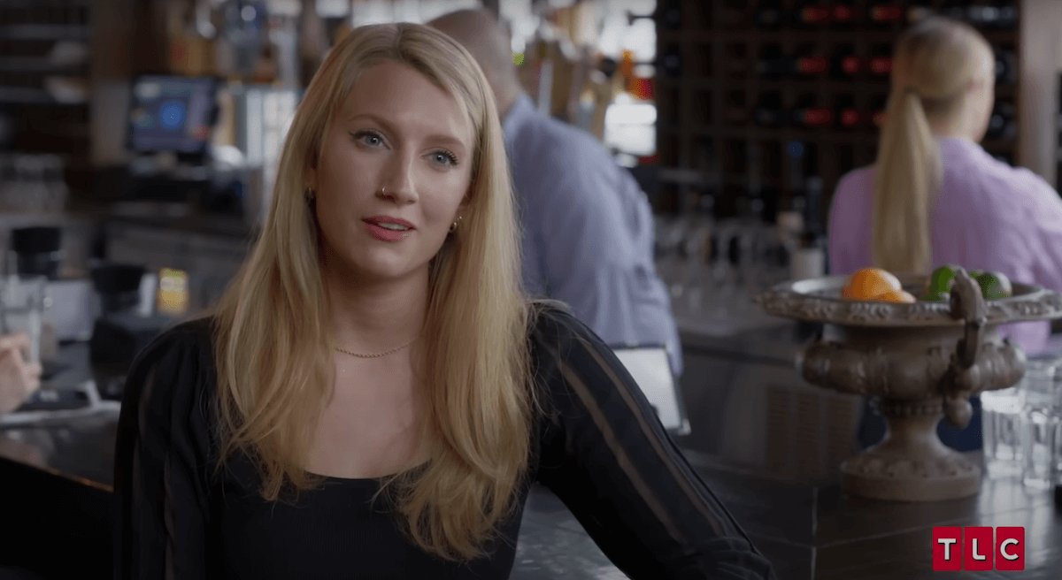 Olivia Plath sitting at a bar in an episode of 'Welcome to Plathville'