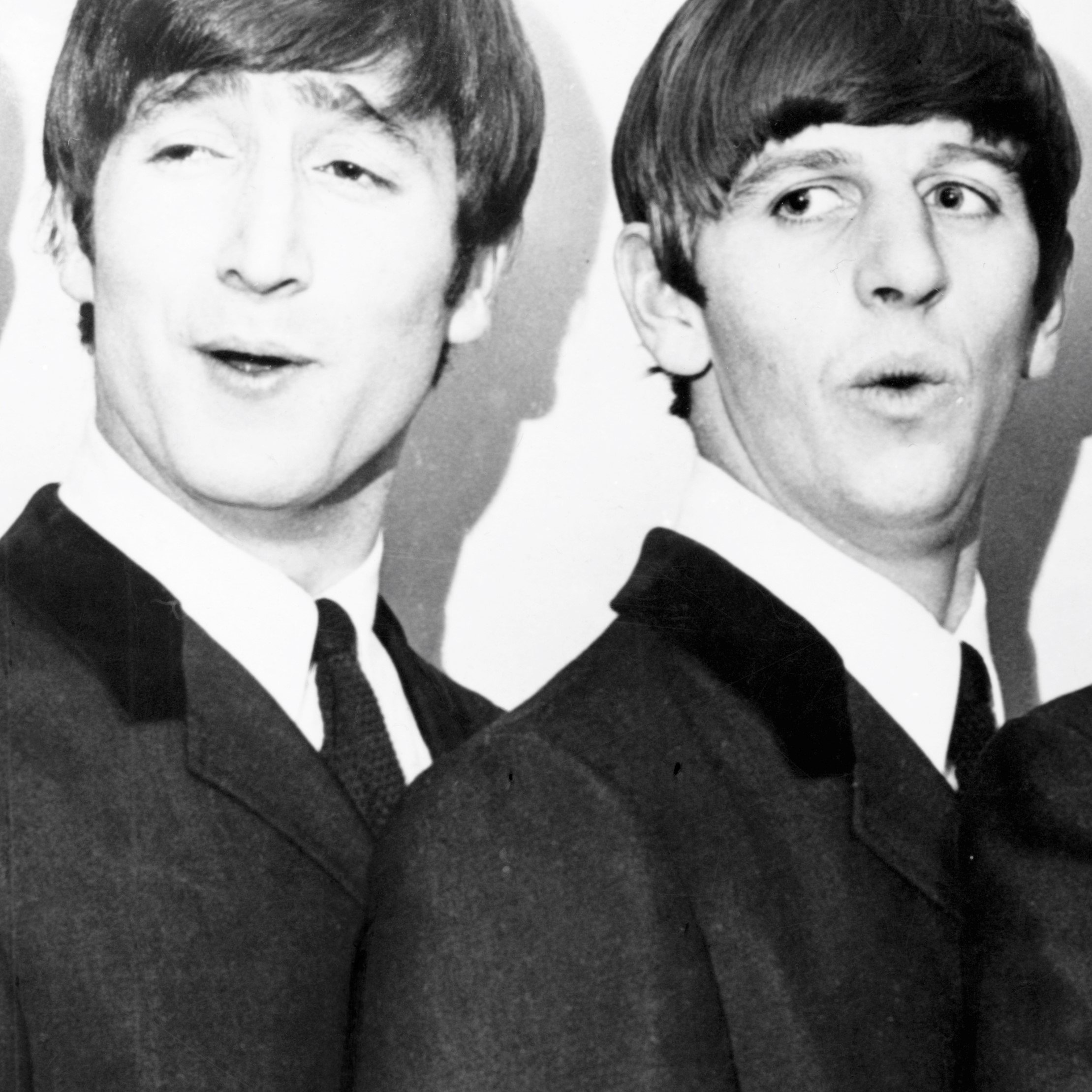 The Beatles' John Lennon and Ringo Starr wearing suits