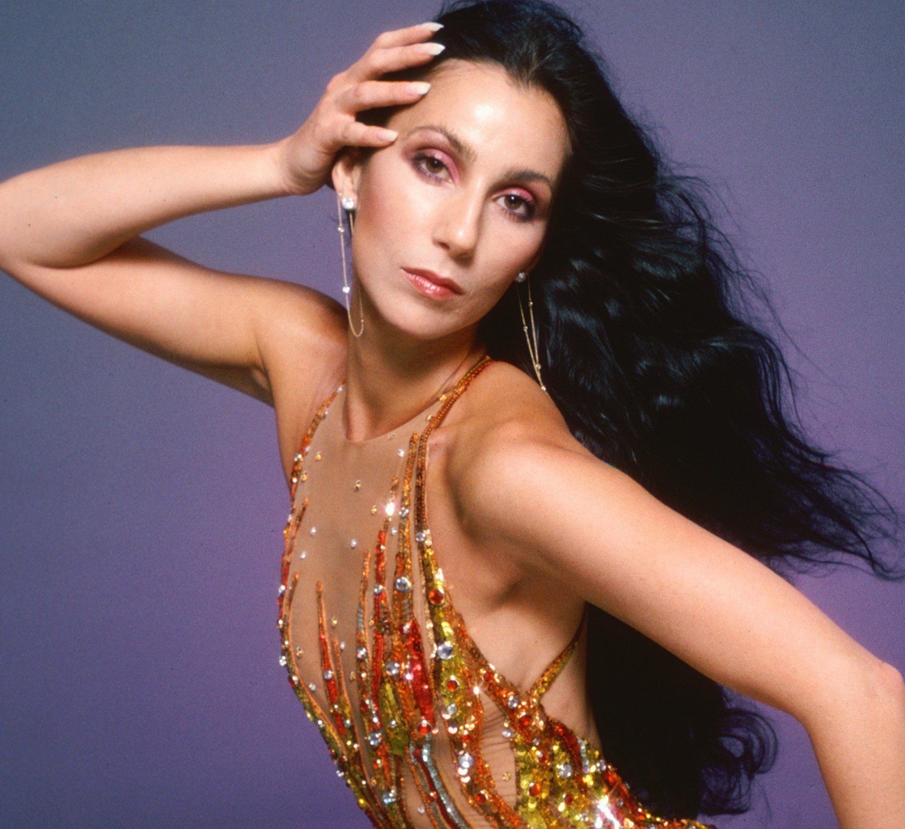 Cher in a gold dress