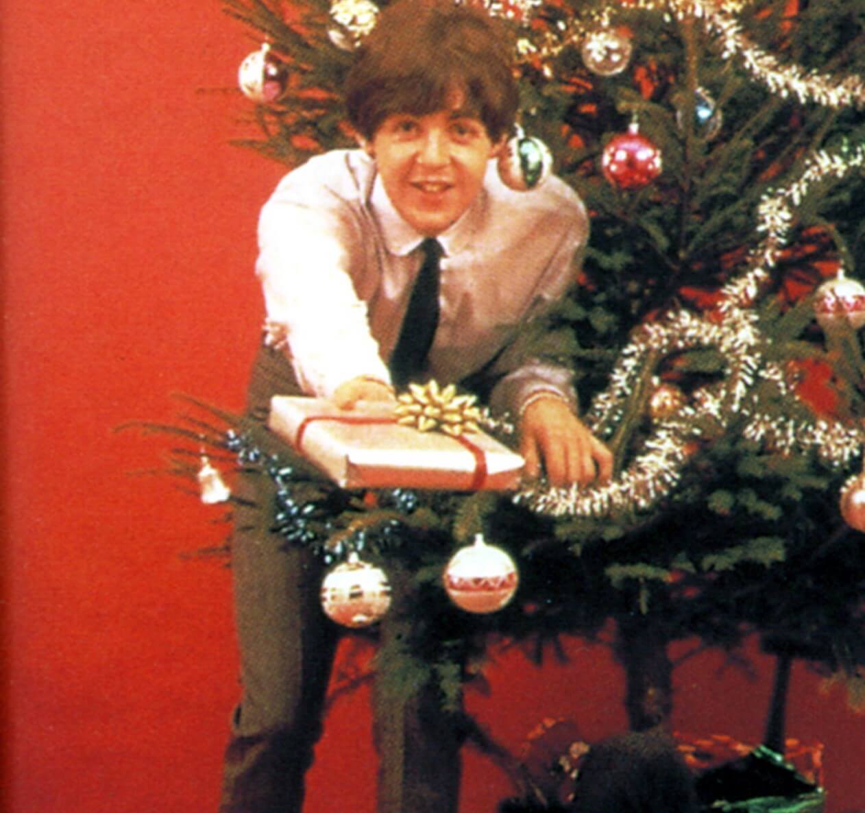 "Wonderful Christmastime" singer Paul McCartney near a tree