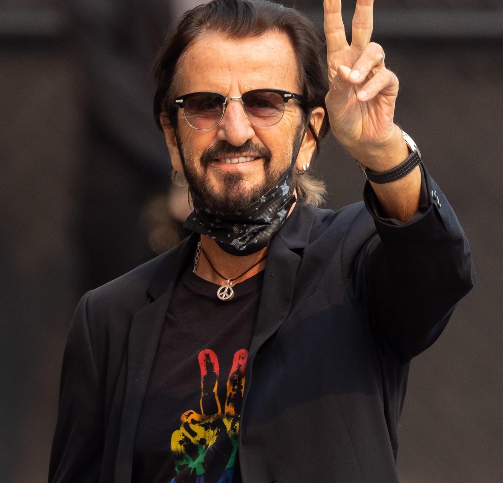 The Beatles' Ringo Starr raising his hand