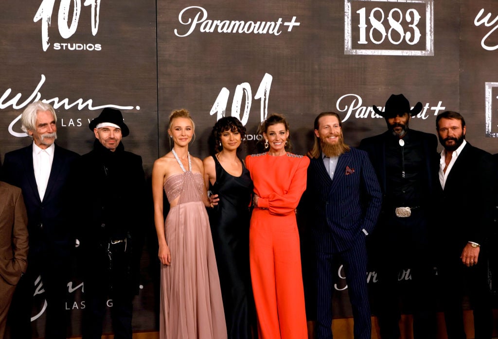 The '1883' cast behind the TV series characters pose at the premiere.