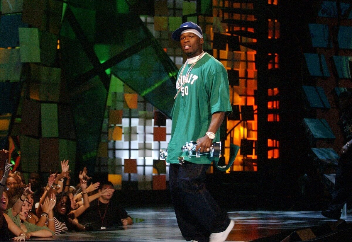 50 Cent on stage wearing a G-Unit shirt and black pants at the MTV Music awards.