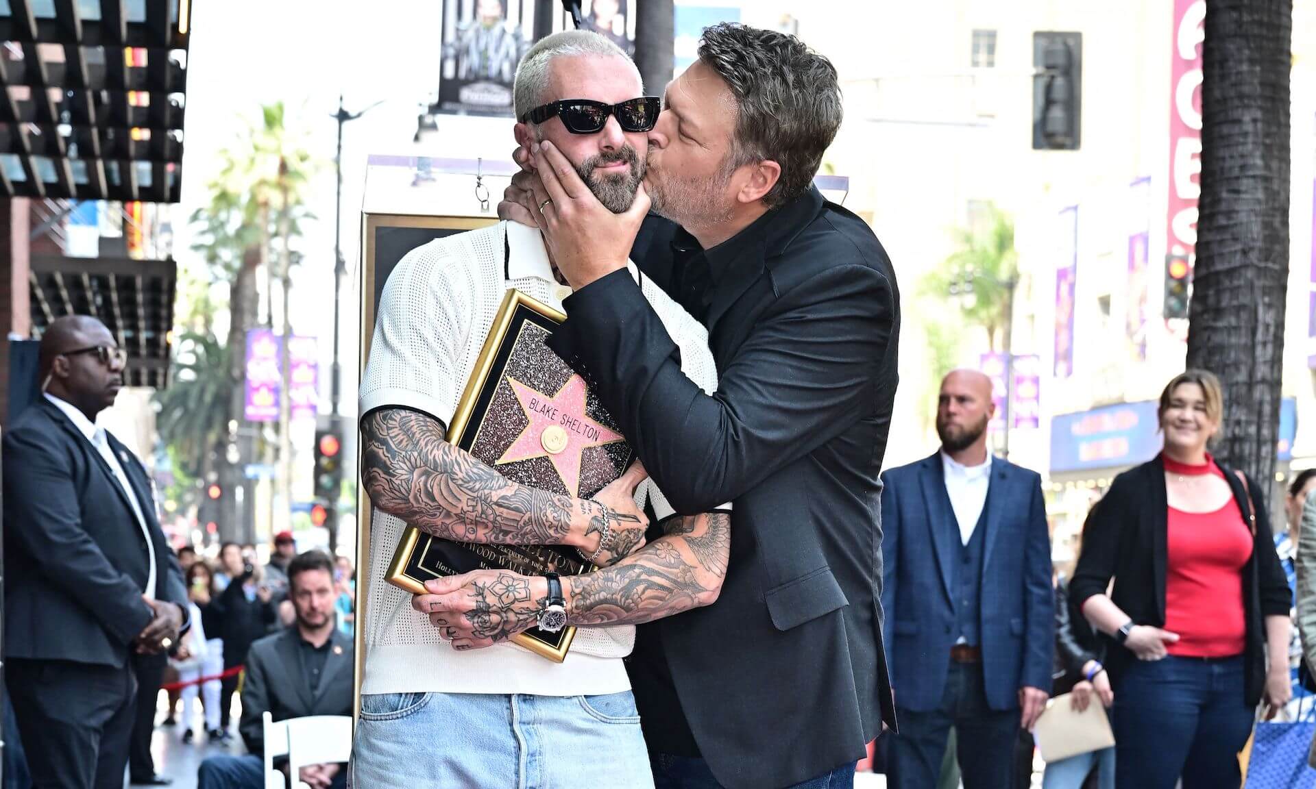 'The Voice' coach Blake Shelton kissing Adam Levine on the cheek at Shelton's Hollywood Walk of Fame ceremony