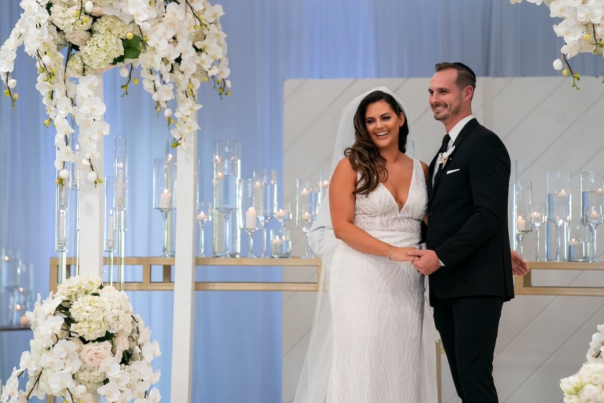 Alexa and Brennon smiling at the altar on their wedding day