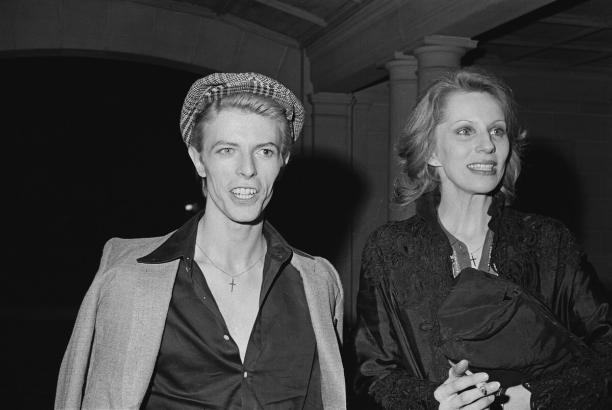 Angie Bowie standing with ex-husband David Bowie at a reception given by the American Film Institute for film director Michelangelo Antonioni at Greystone Mansion,