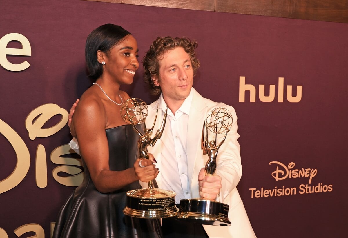 Jeremy Allen White and Ayo Edebiri both holding their Emmy Awards.
