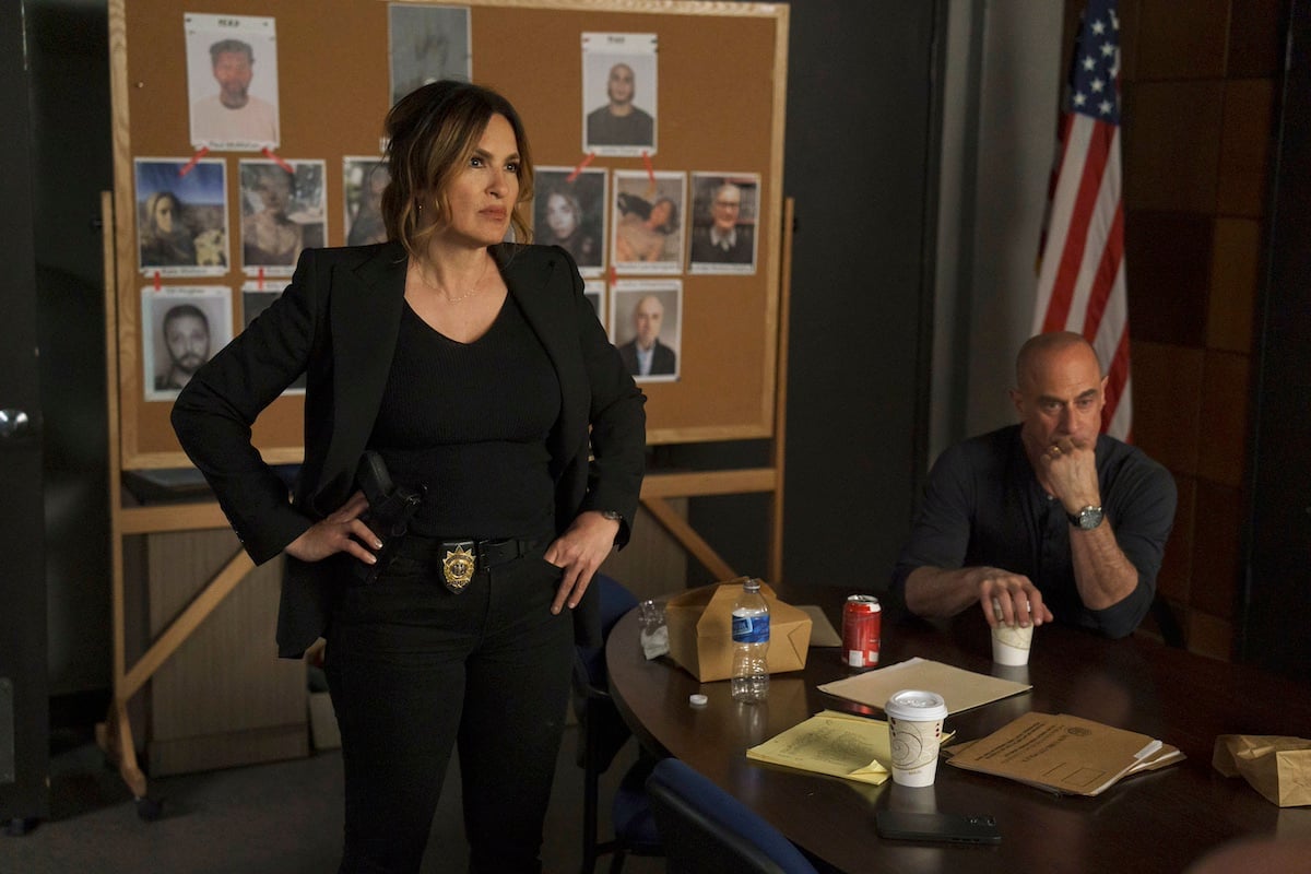 Olivia Benson standing in front of a cork board with Stabler seated behind a desk