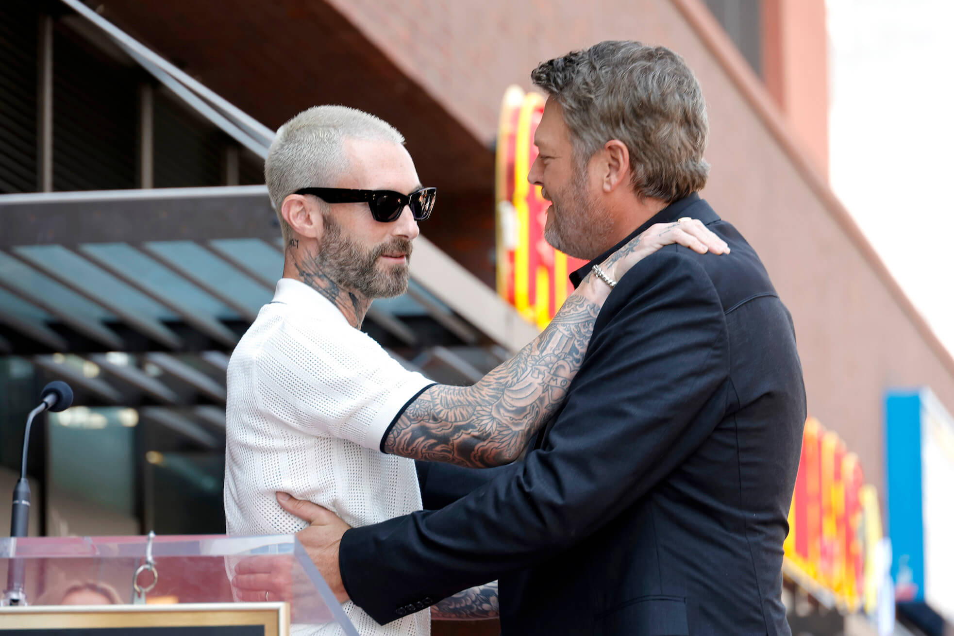 Blake Shelton and Adam Levine hugging at the Hollywood Walk of Fame