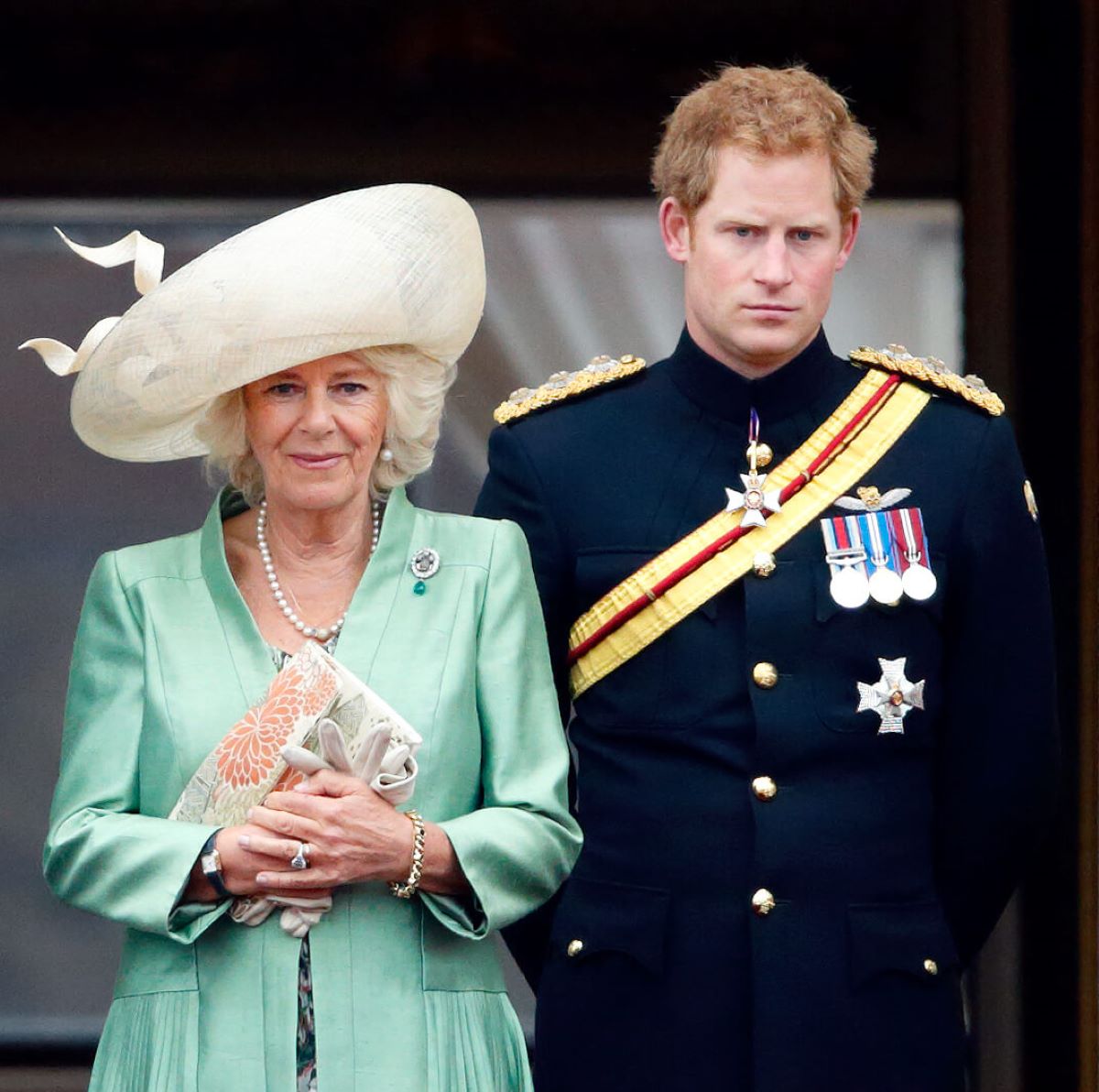 Camilla Parker Bowles (now Queen Camilla) and Prince Harry stand on the balcony of Buckingham Palace during Trooping the Colour